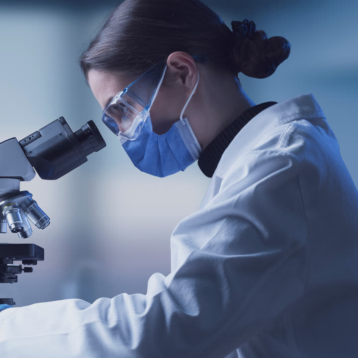 Researcher at a microscope